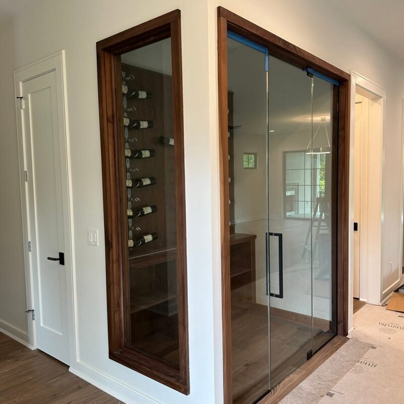 Glass wine room with wood frame door